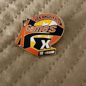 Black and Orange Game Badge with Dynamic Design  New in original shrink wrap.